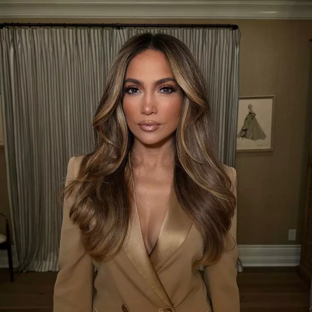 Caramel face-framing highlights on dark hair