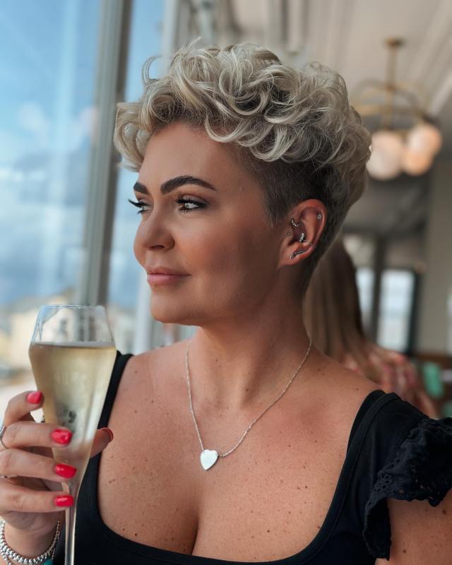 Curly undercut pixie with a textured top short hair hairstyle