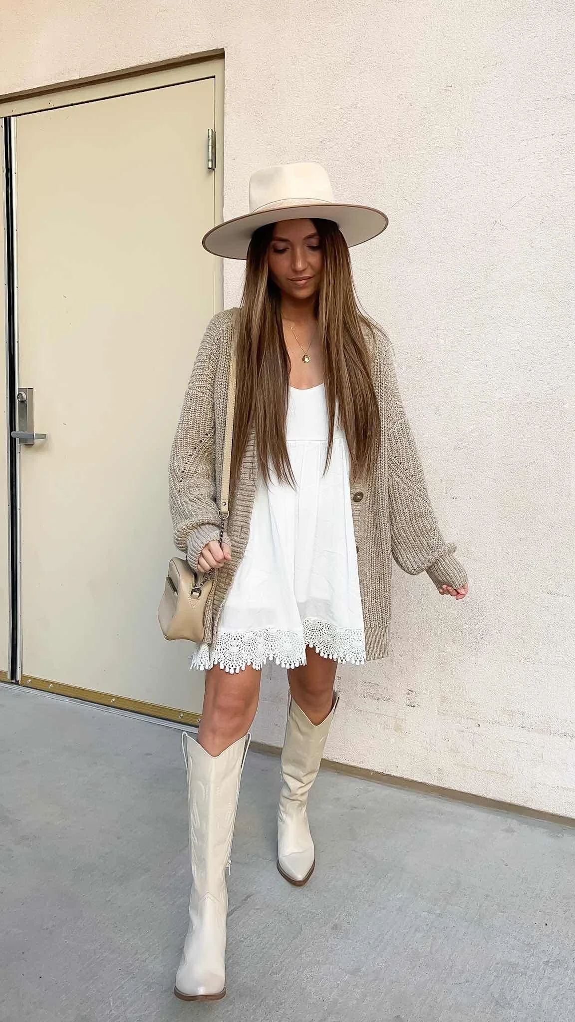 White mini dress under an oversized cardigan