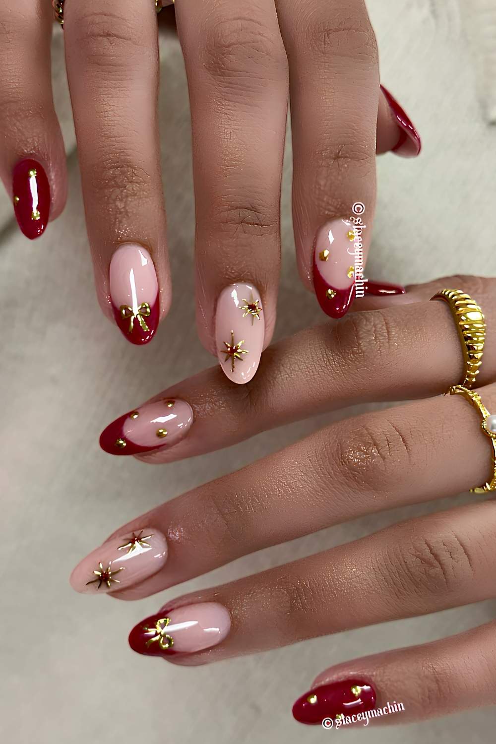 Deep Red Nails with Gold Chrome Stars and Bows elegant christmas nail design