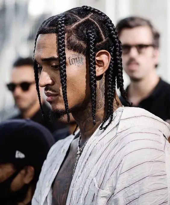 Double braids giving locs a structured finish