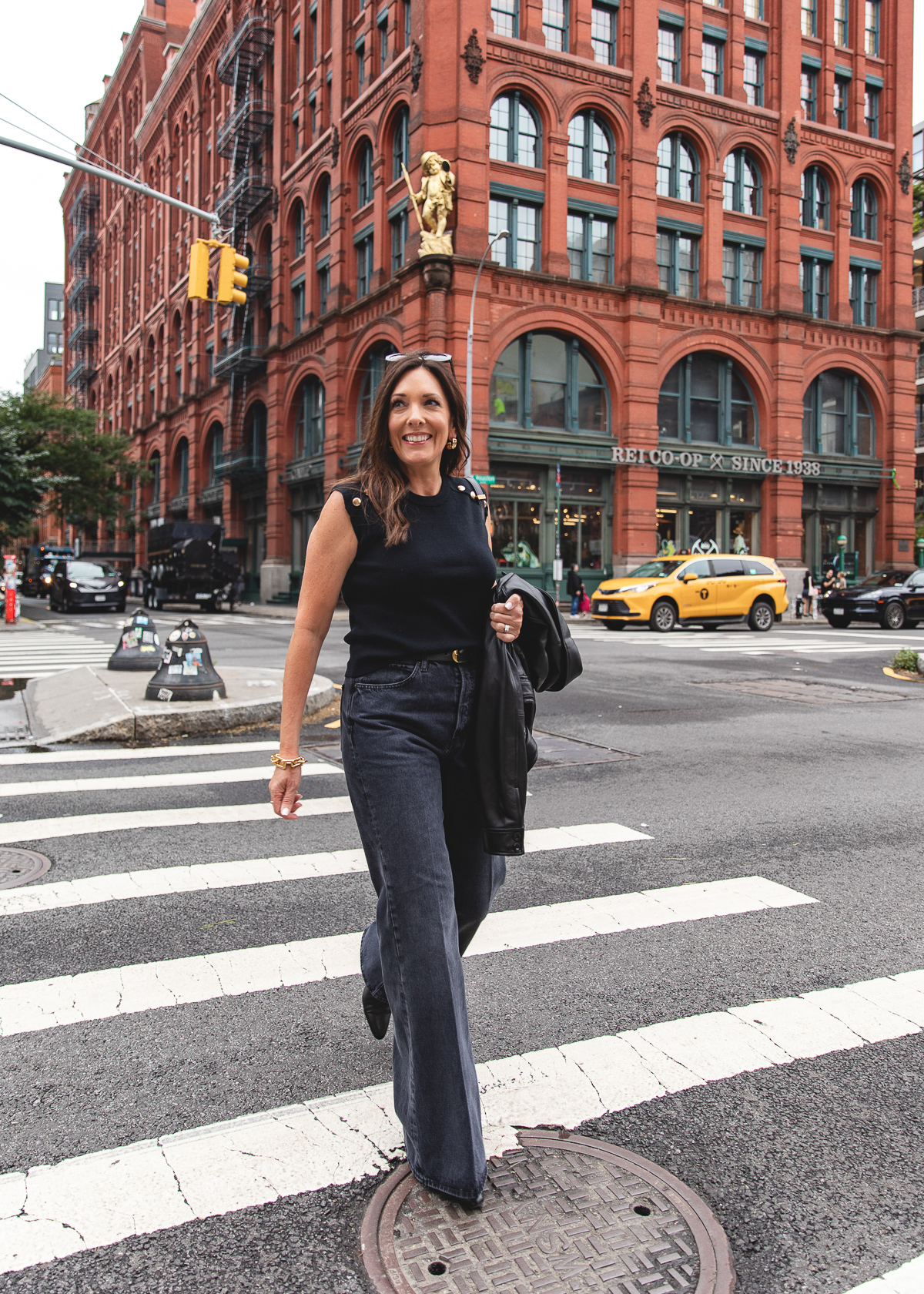 All-black layers with a leather jacket and relaxed flare jeans