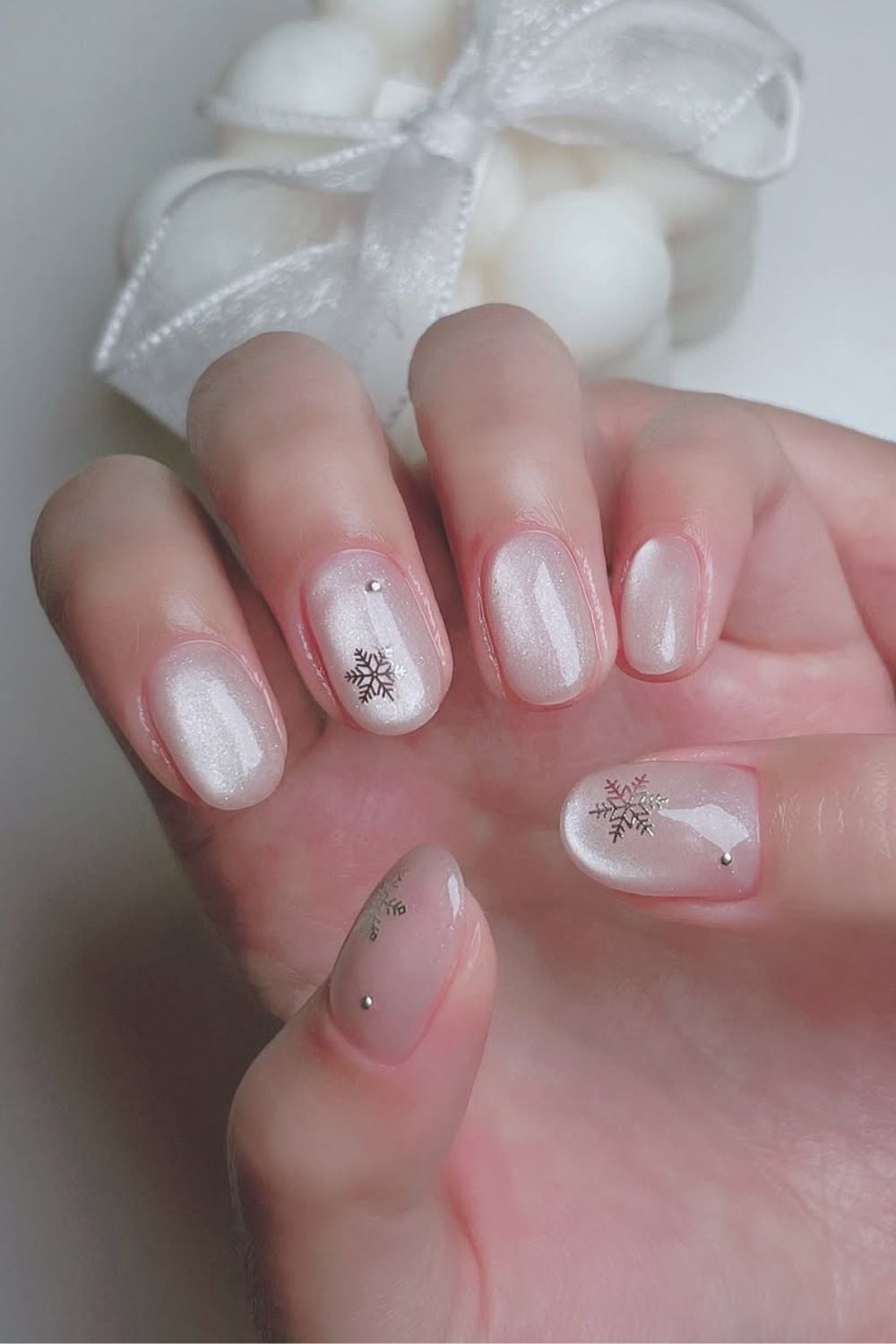 Glass-Effect Iridescent Snowflake Nails snowflake nail art design