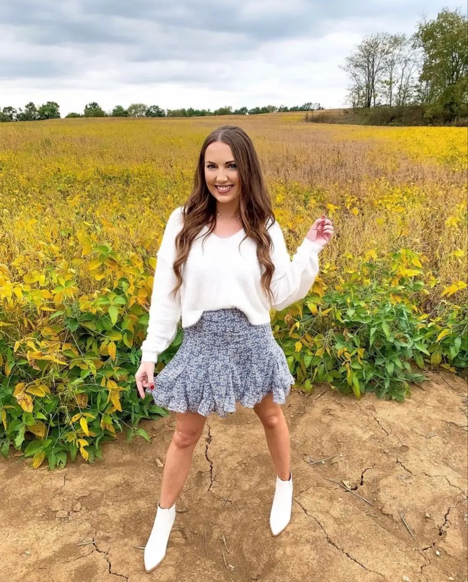 White fuzzy sweater with a printed mini skirt