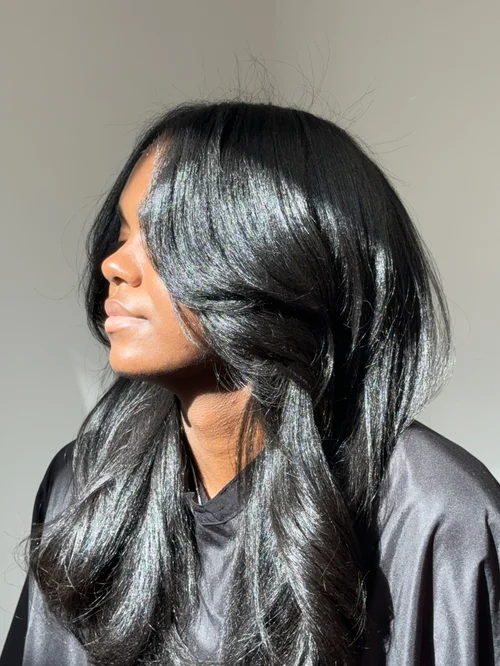 Voluminous layered haircut with soft bouncy curls