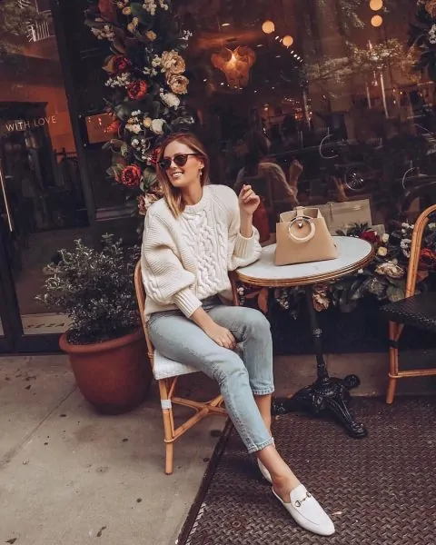 Sleek mules paired with a chunky cable-knit sweater