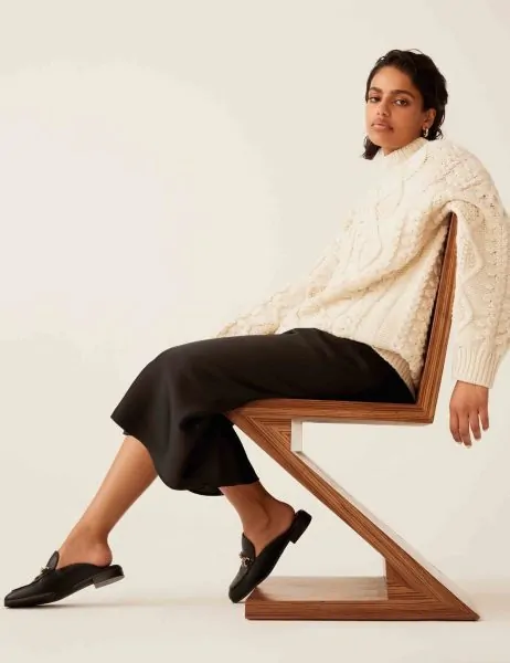 Black mules worn with a midi skirt