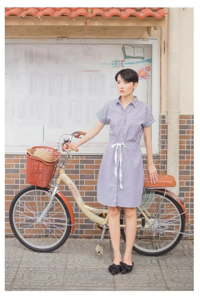 Black loafer mules with a blue and white striped shirt dress