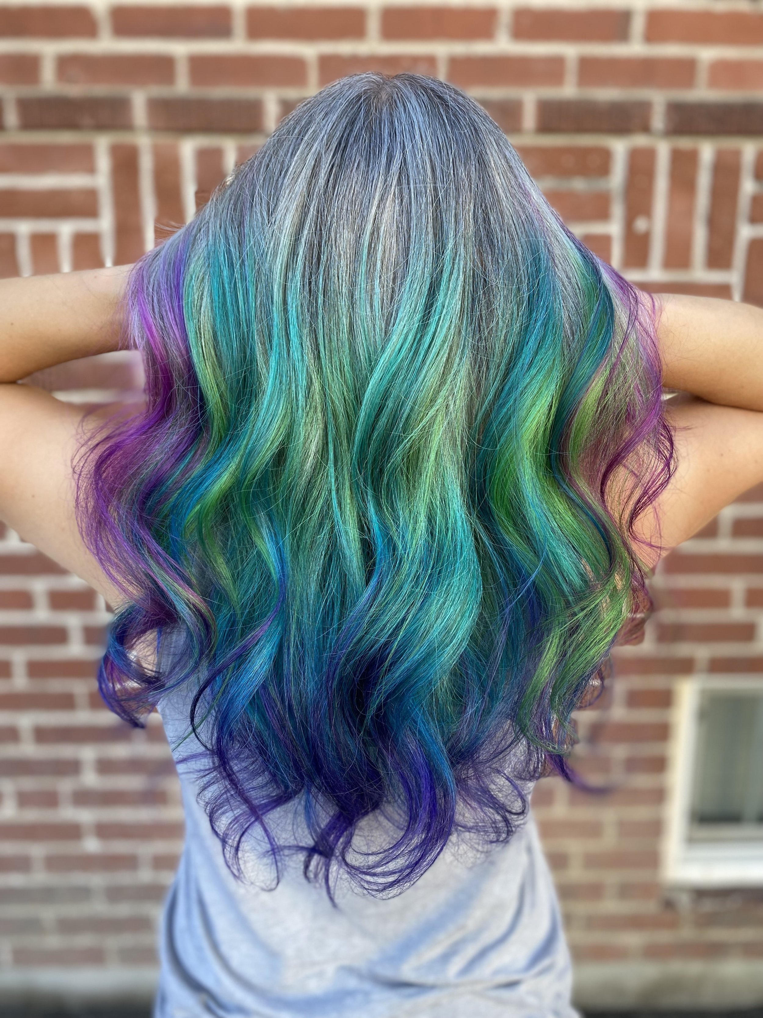 Emerald teal color through long layered hair
