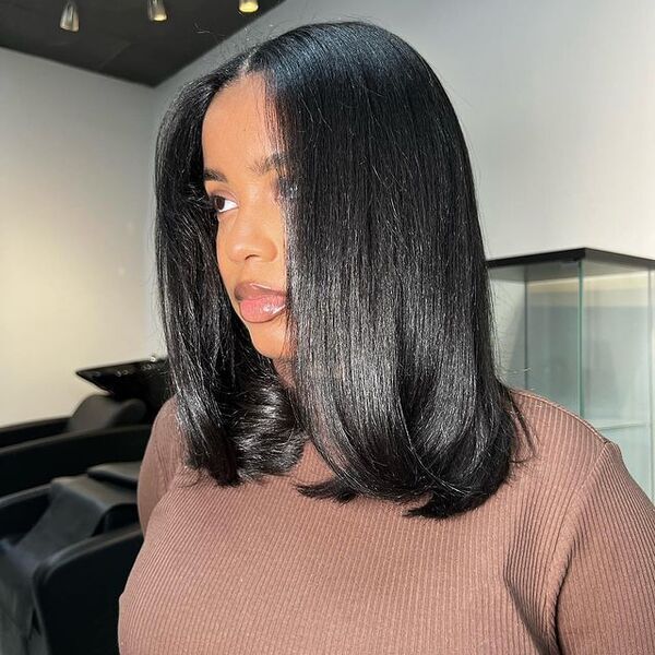 Lob with a middle part and ends that flick in and out silk press hairstyle