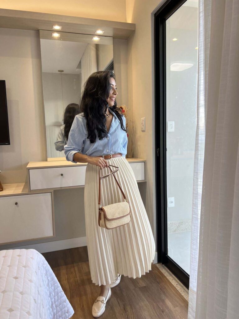 Pinstripe shirt with a cream accordion skirt and loafers church outfit