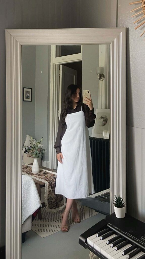 White slip dress layered over a chocolate brown blouse church outfit