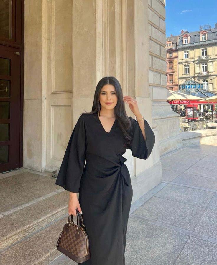 Black wrap dress with a structured handbag church outfit