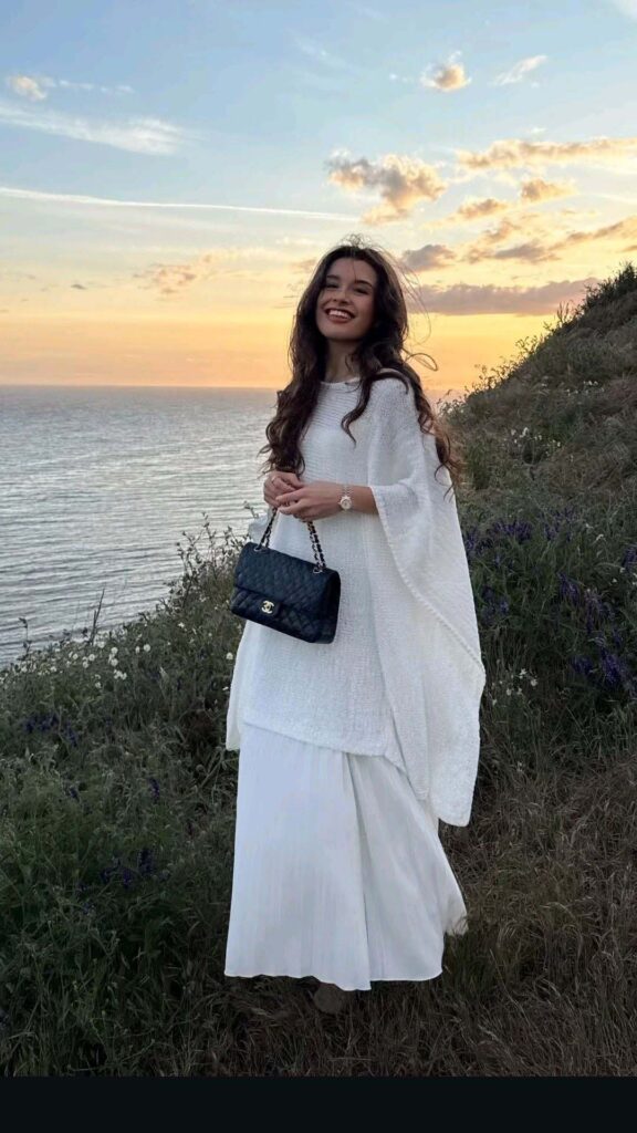 White poncho sweater with a pleated column skirt church outfit