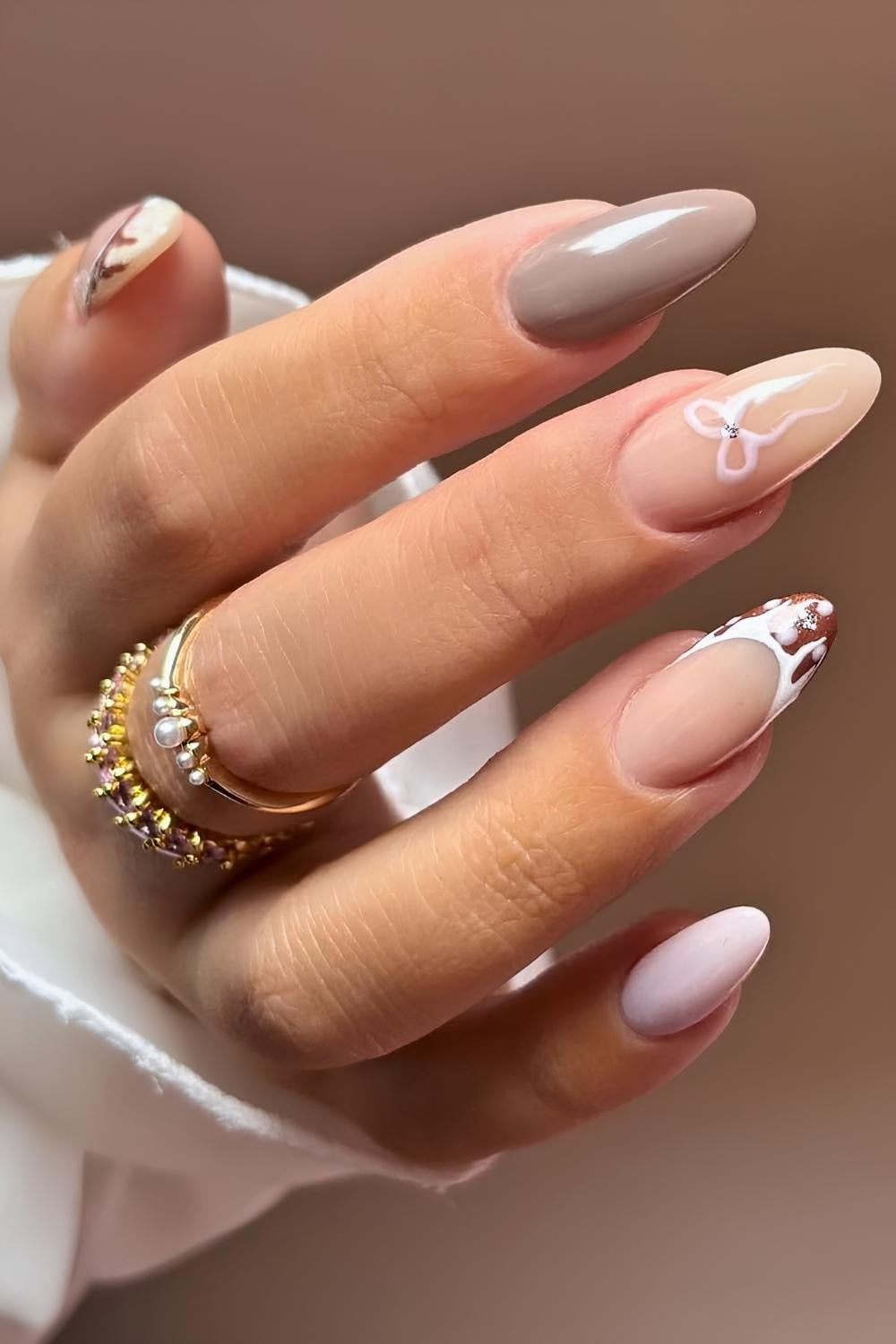 Neutral Almond Nails with Gingerbread Detail and Bow French Accents holiday nails