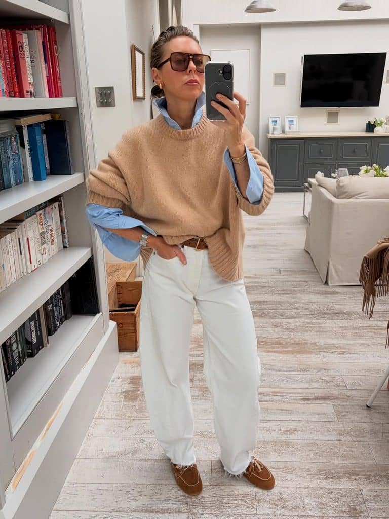 Camel oversized sweater over a blue shirt with white jeans