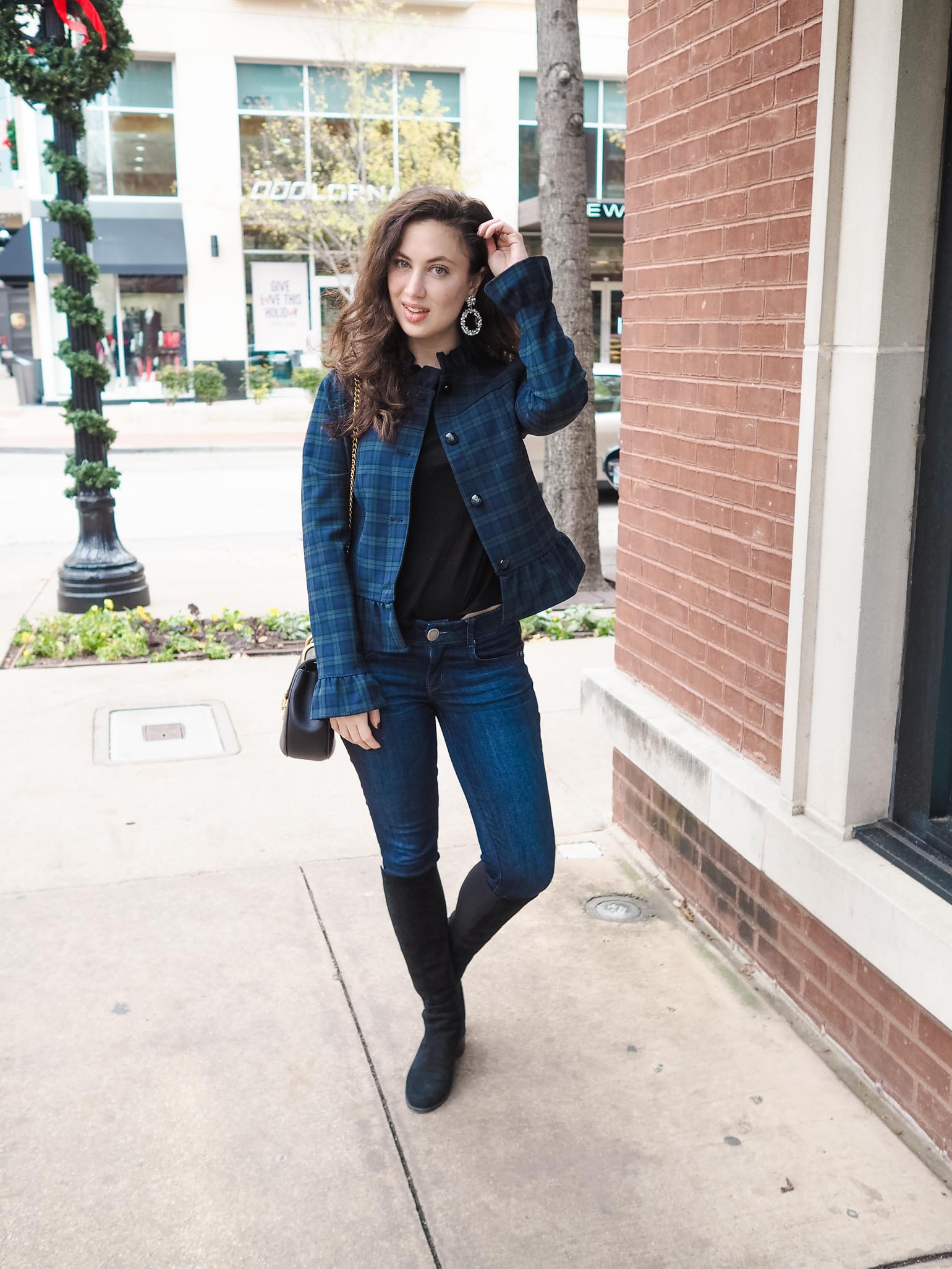 Woman wearing a checked flannel shacket coat
