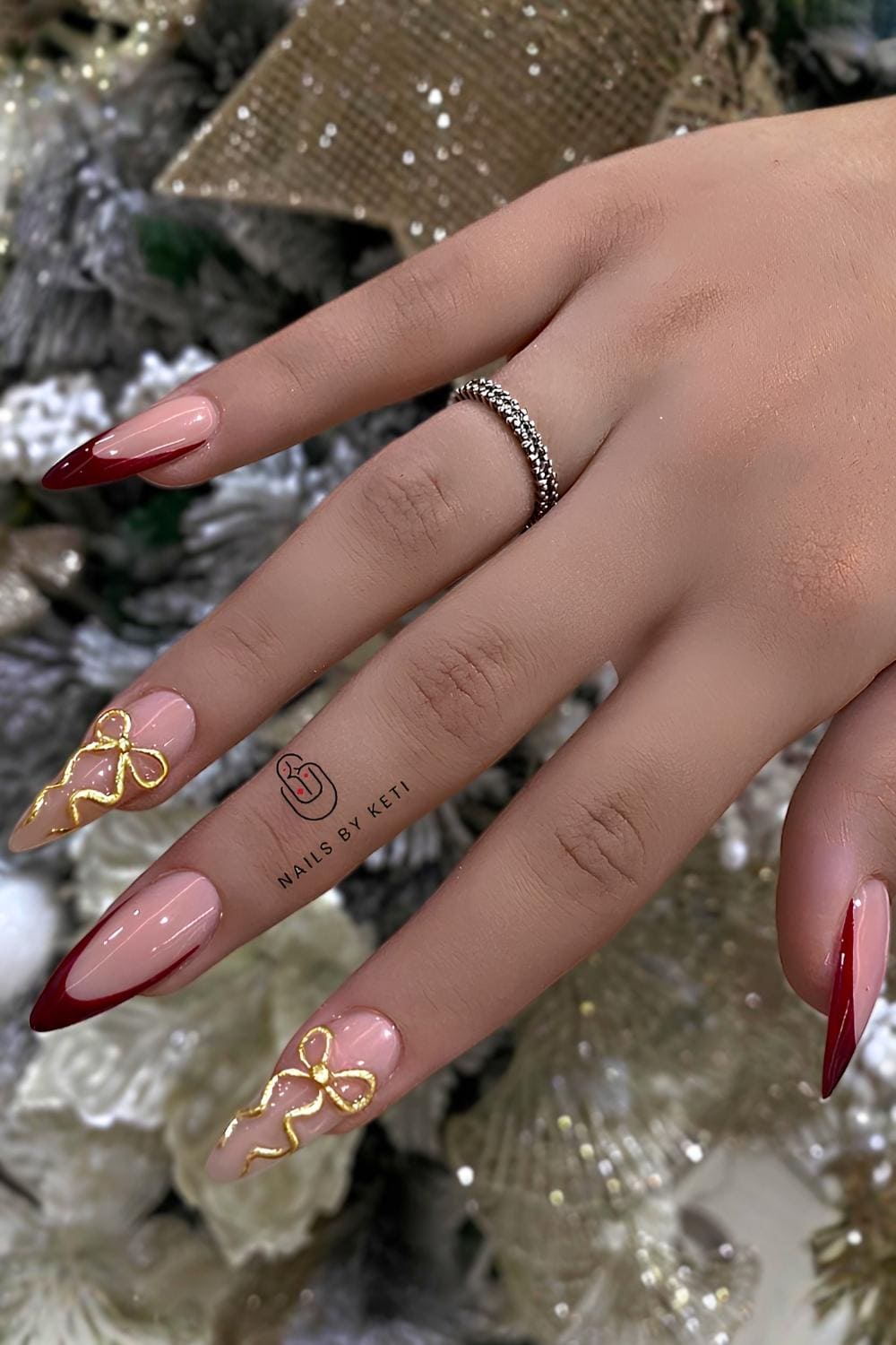 Dimensional Bows on Classic Red French Tips christmas acrylic nail design
