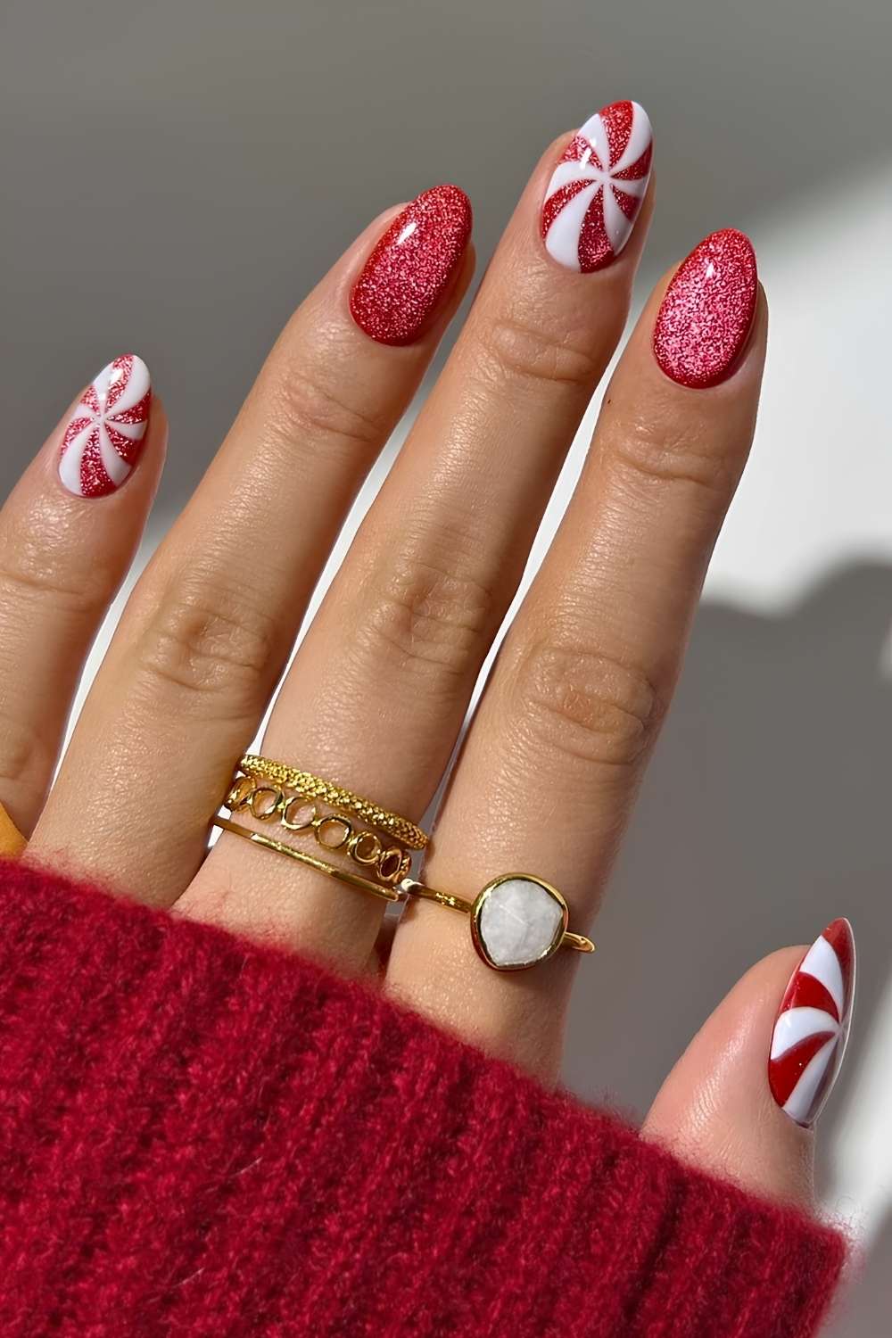 Oversized Peppermint Swirls on a Red Velvet Base red and white nail design
