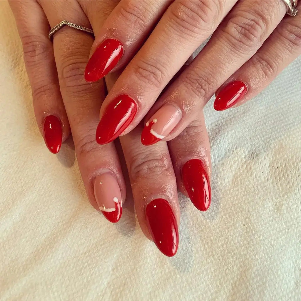 Short Oval Nails with a Santa Face and Glitter Red Polish santa hat nail design