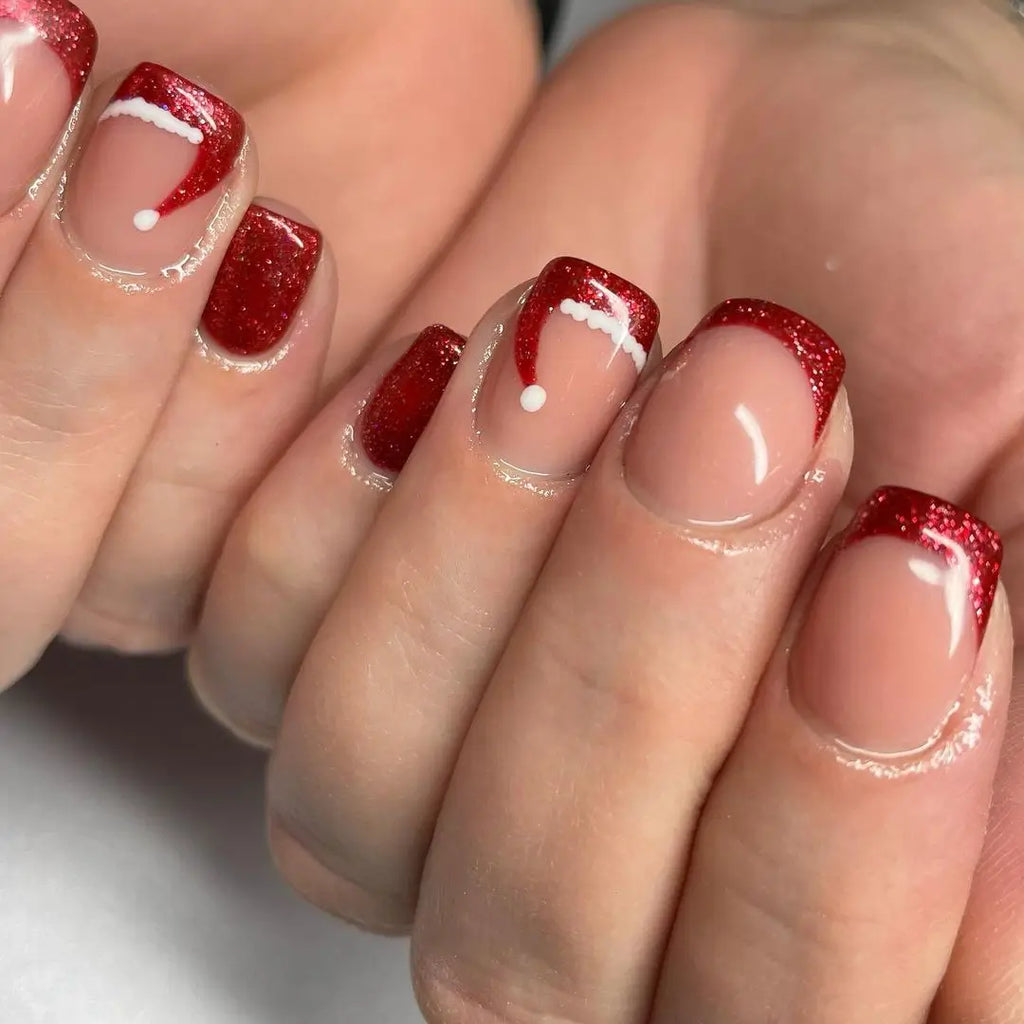 Sheer Nude Almond Nails with a Hat on Every Tip santa hat nail design