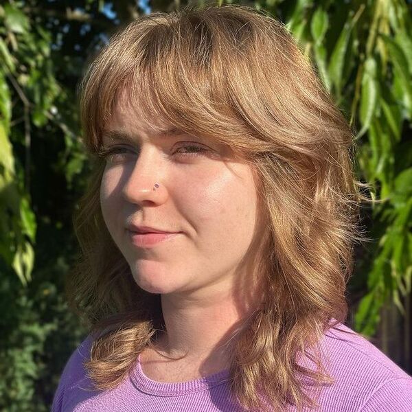 Soft mullet with bright blonde balayage, short front and long back