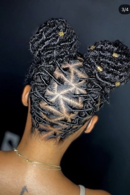 Messy space buns styled on medium locs