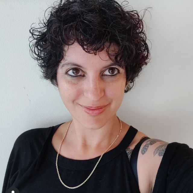 Tousled curly pixie with a wet-look finish short hair hairstyle