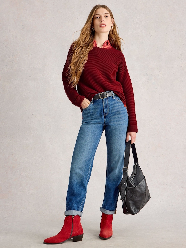 Red sweater worn with blue jeans and ankle boots