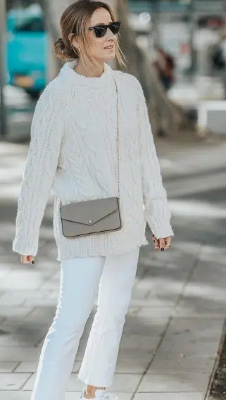 Oversized cable knit sweater with white wide-leg trousers