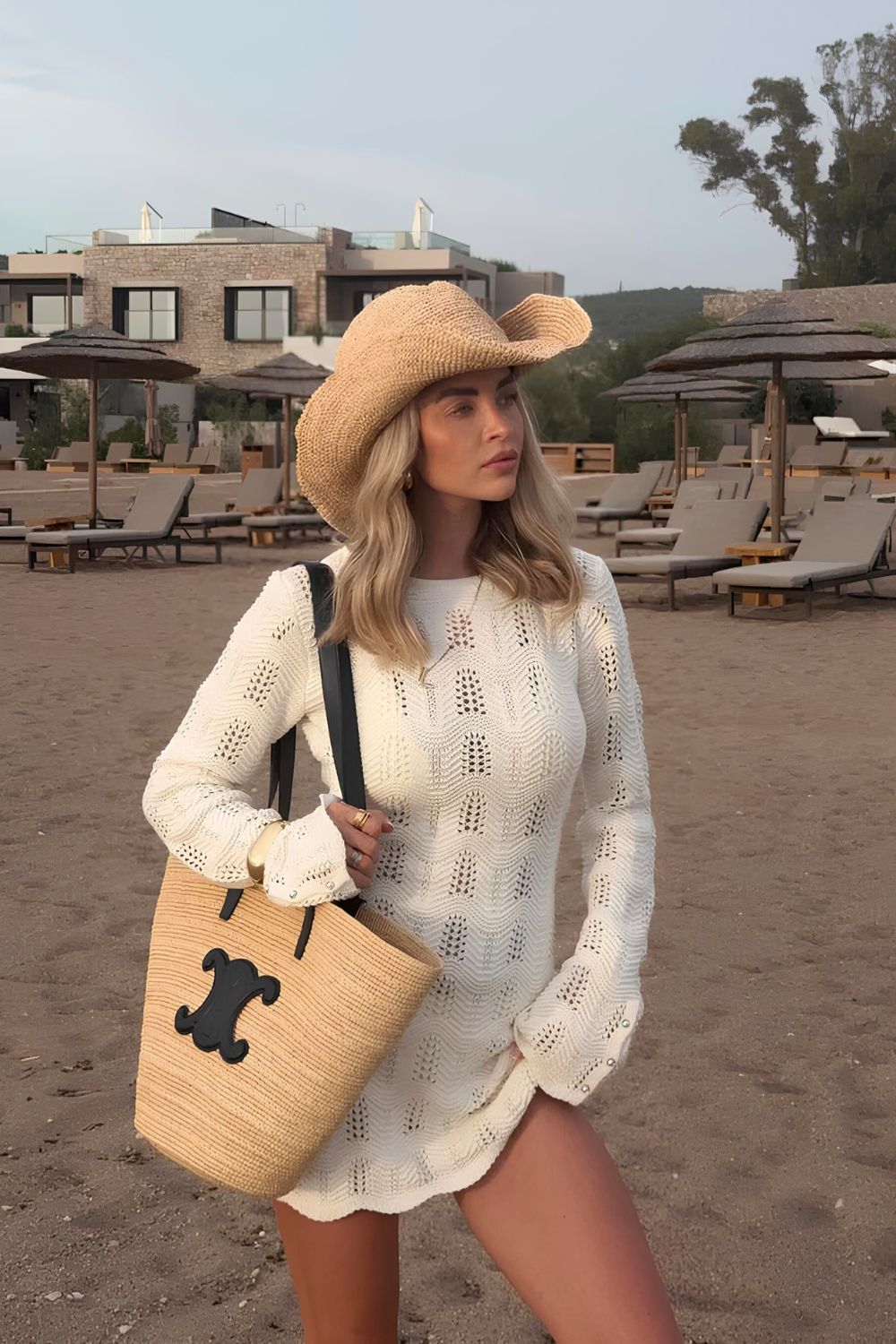 White knitted beach dress with a straw hat