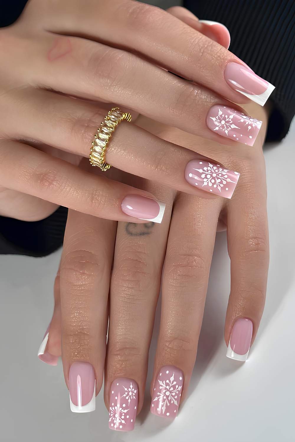 Pink French Nails with Glitter Snowflake Accents classy Christmas nail manicure