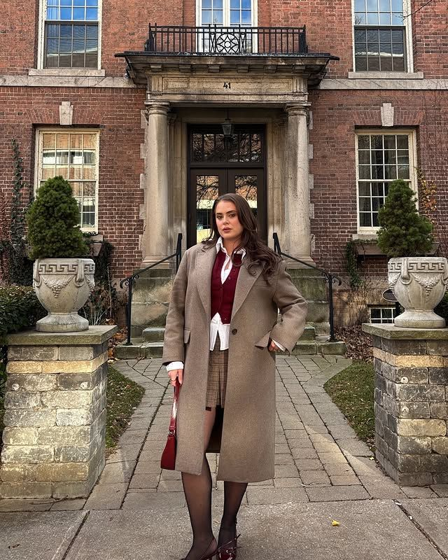Long wool coat over a vest and plaid skirt preppy outfit