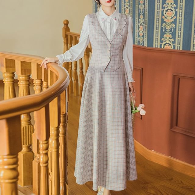 Fitted Button-Up Vest with a Full A-Line Skirt Button-up vest worn with a floral shirt and midi A-line skirt