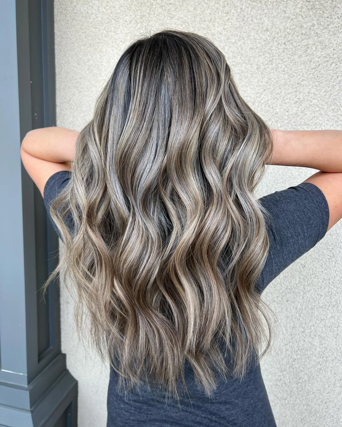 Beige-softened ash blonde hair in soft waves