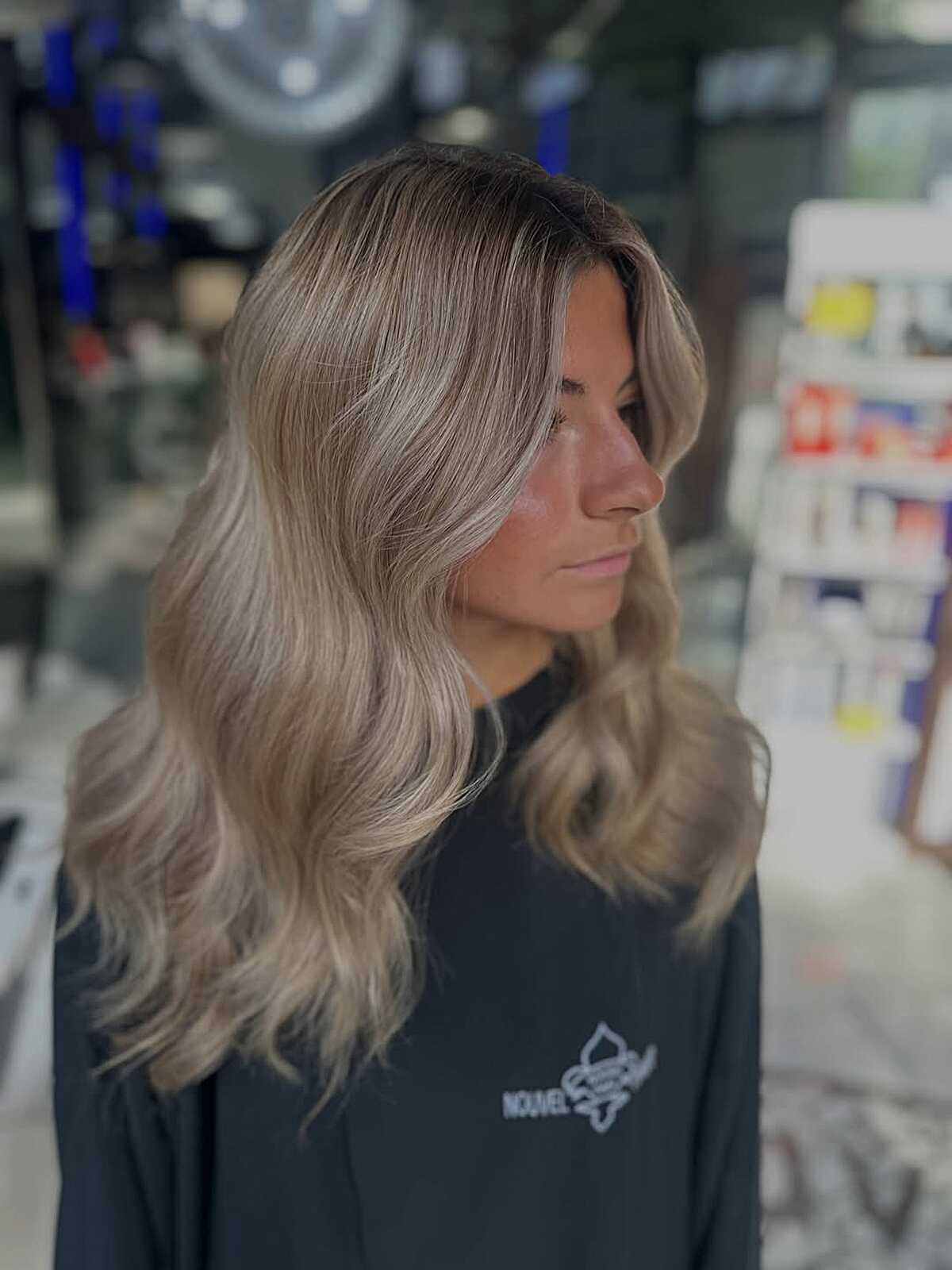 Shoulder-Length Ash Blonde Waves with a Wispy Fringe wavy hair hairstyle