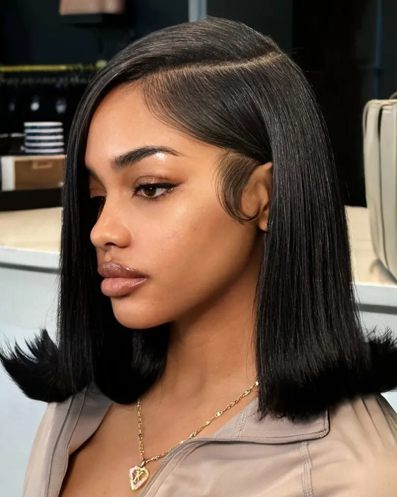 Swoopy side bangs on sleek black lob