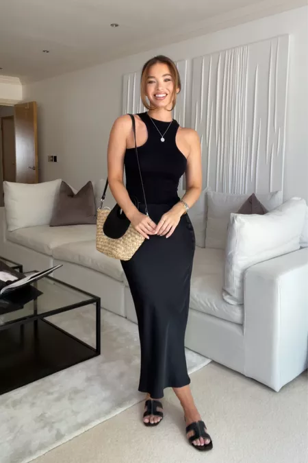 Fitted halter top and sleek black satin midi skirt outfit