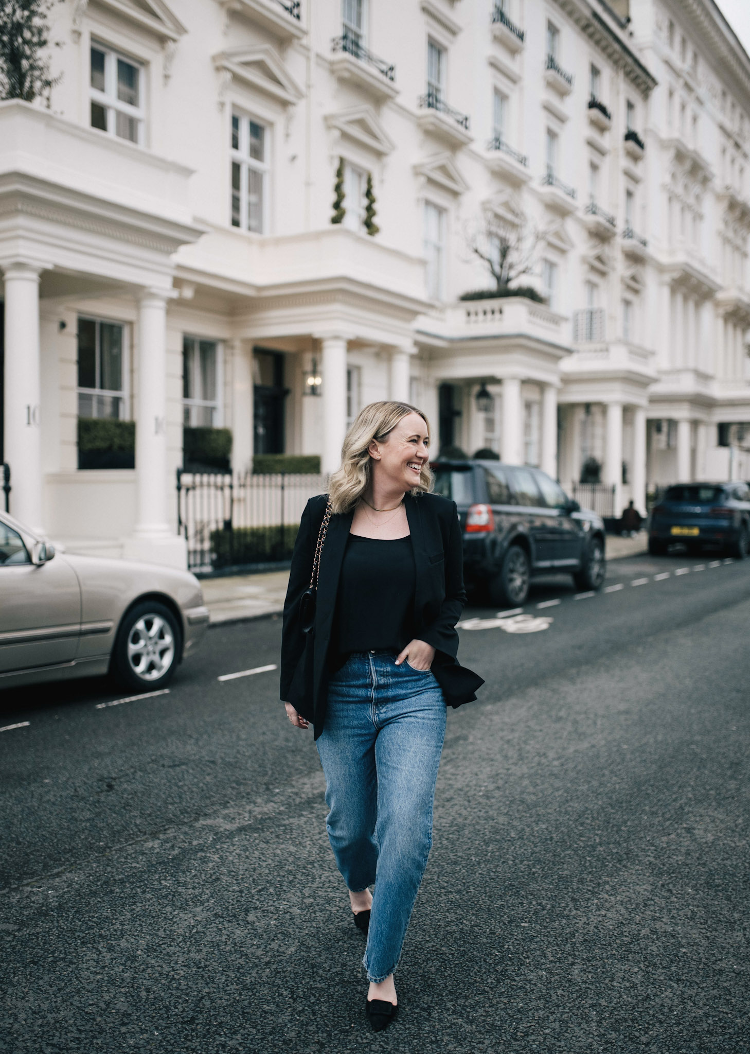Woman wearing a silk blouse and black blazer with high-rise straight jeans LA outfit