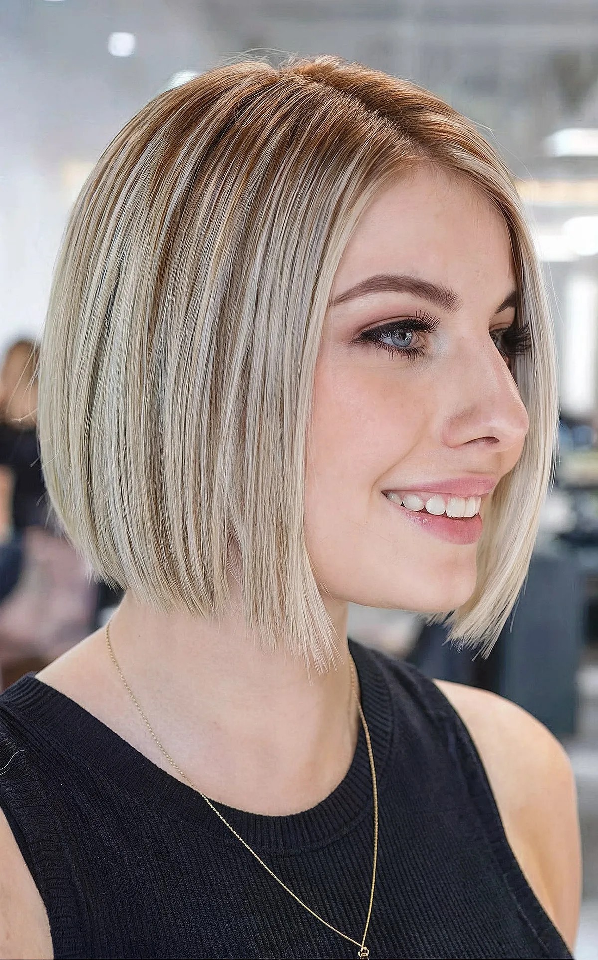 Short bob haircut with highlights and shadow root