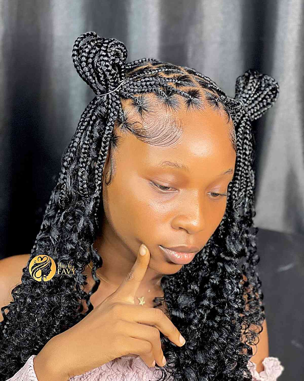 Box braids styled into two high buns braided style