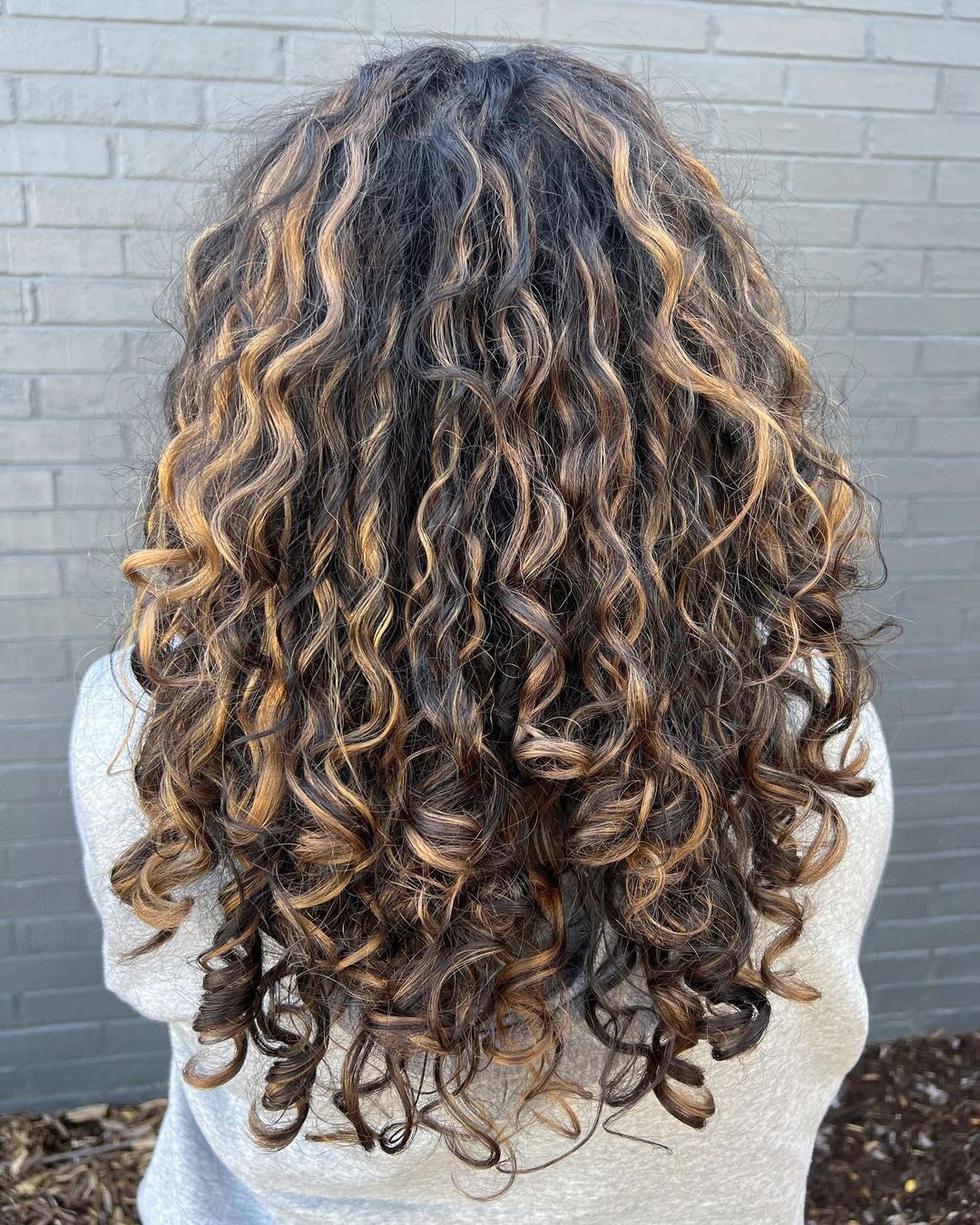 Bronde balayage on layered curly hair