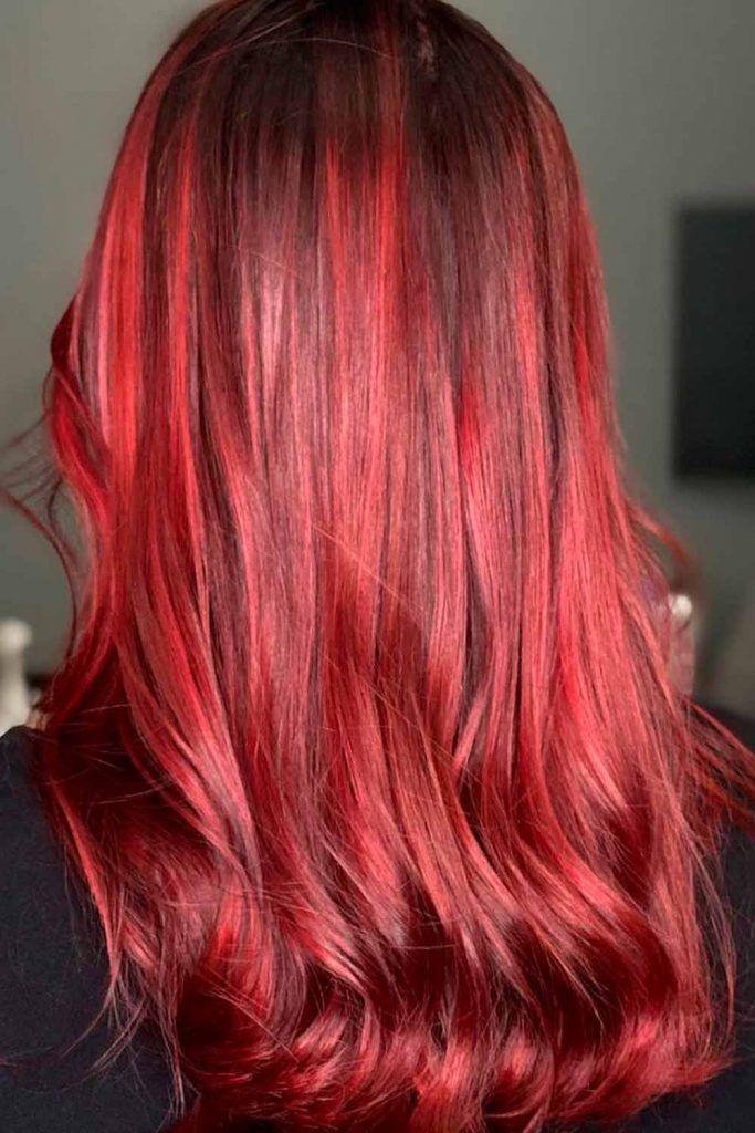 Long hair in brown to burgundy red ombre with waves