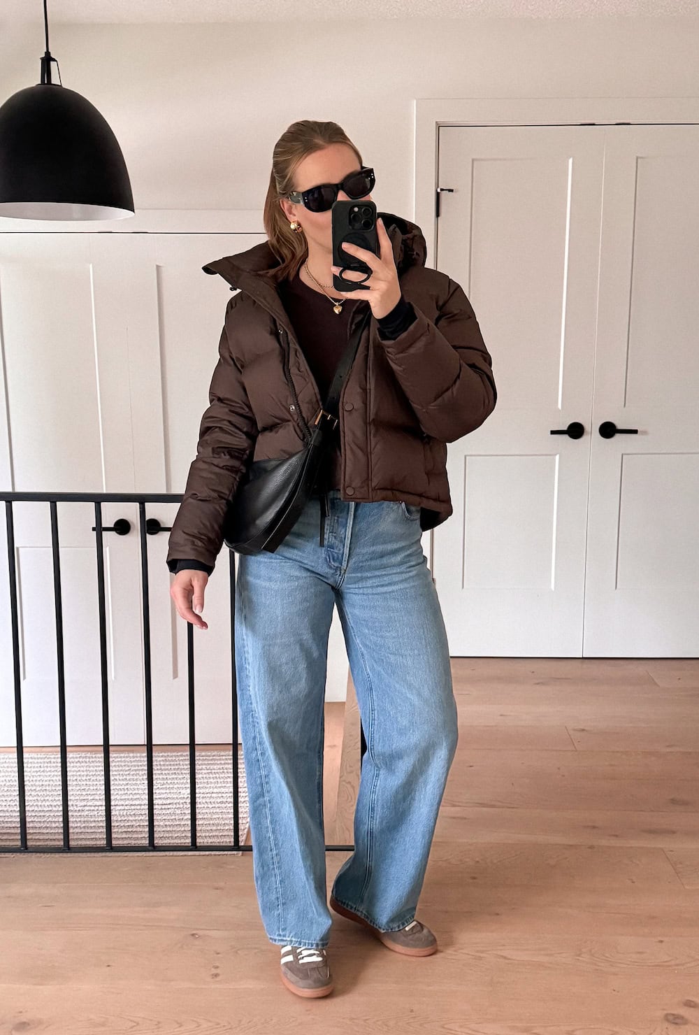 Cropped chocolate puffer jacket with wide-leg jeans and suede sneakers brown outfit