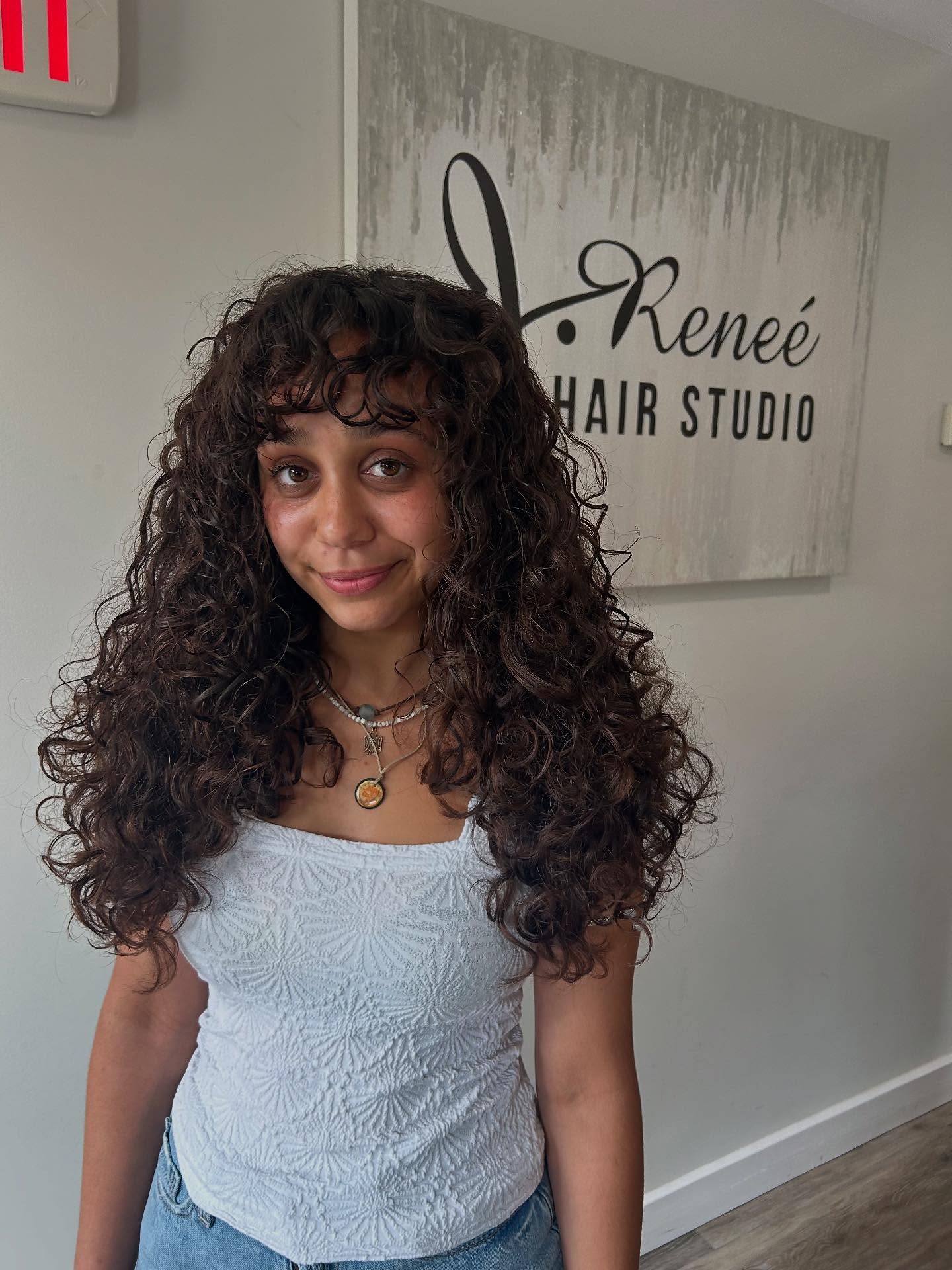 Long loose curls with layered movement and soft bangs
