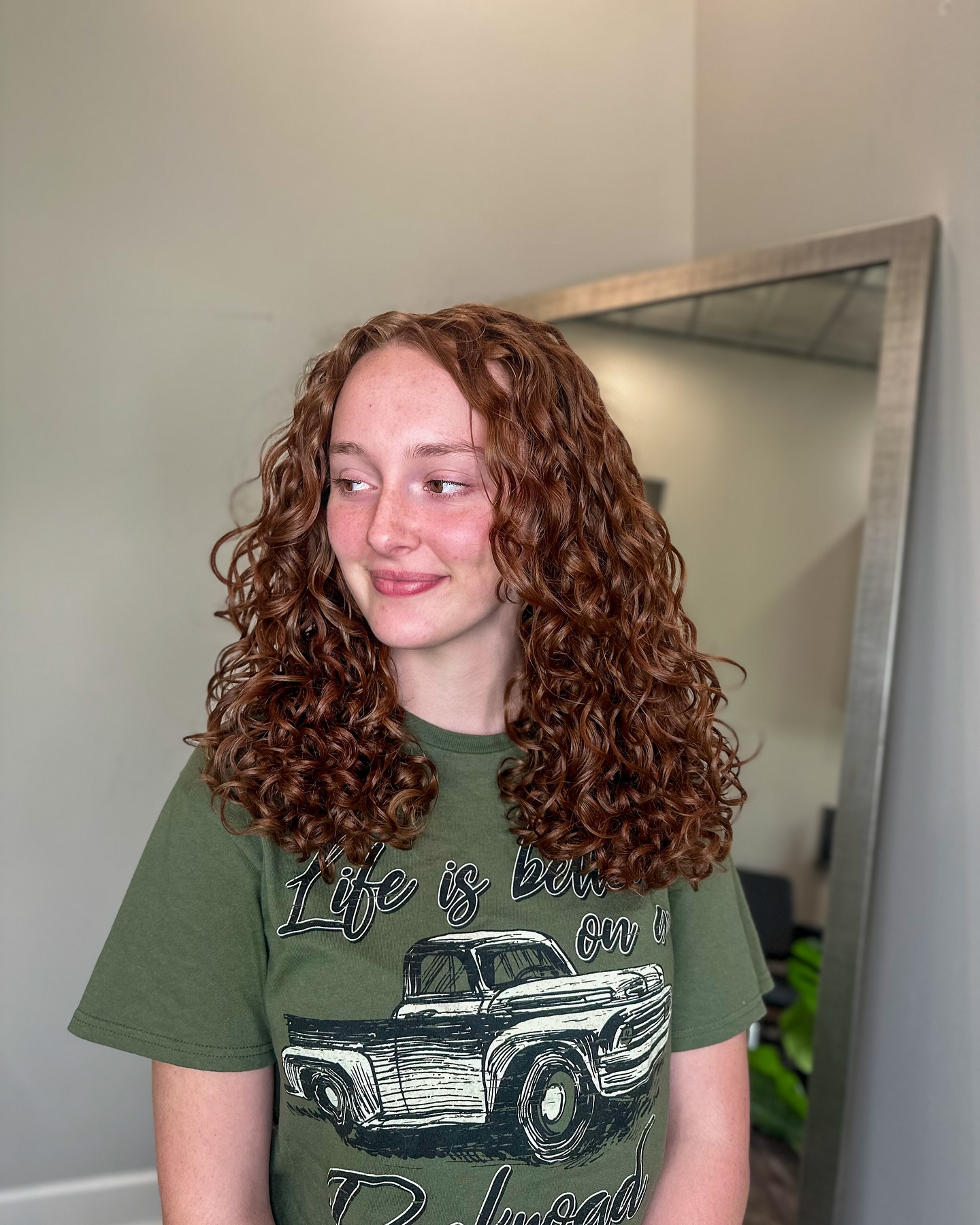 Rounded medium layered curly haircut with natural volume