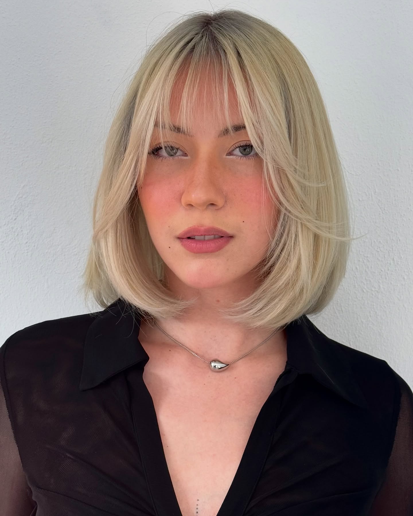Chin-grazing blunt bob with feathered curtain fringe bob haircut