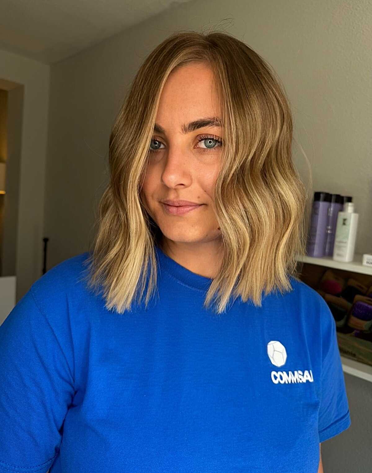 Chin-Length Bob with Subtle Sun-Kissed Highlights wavy hair hairstyle