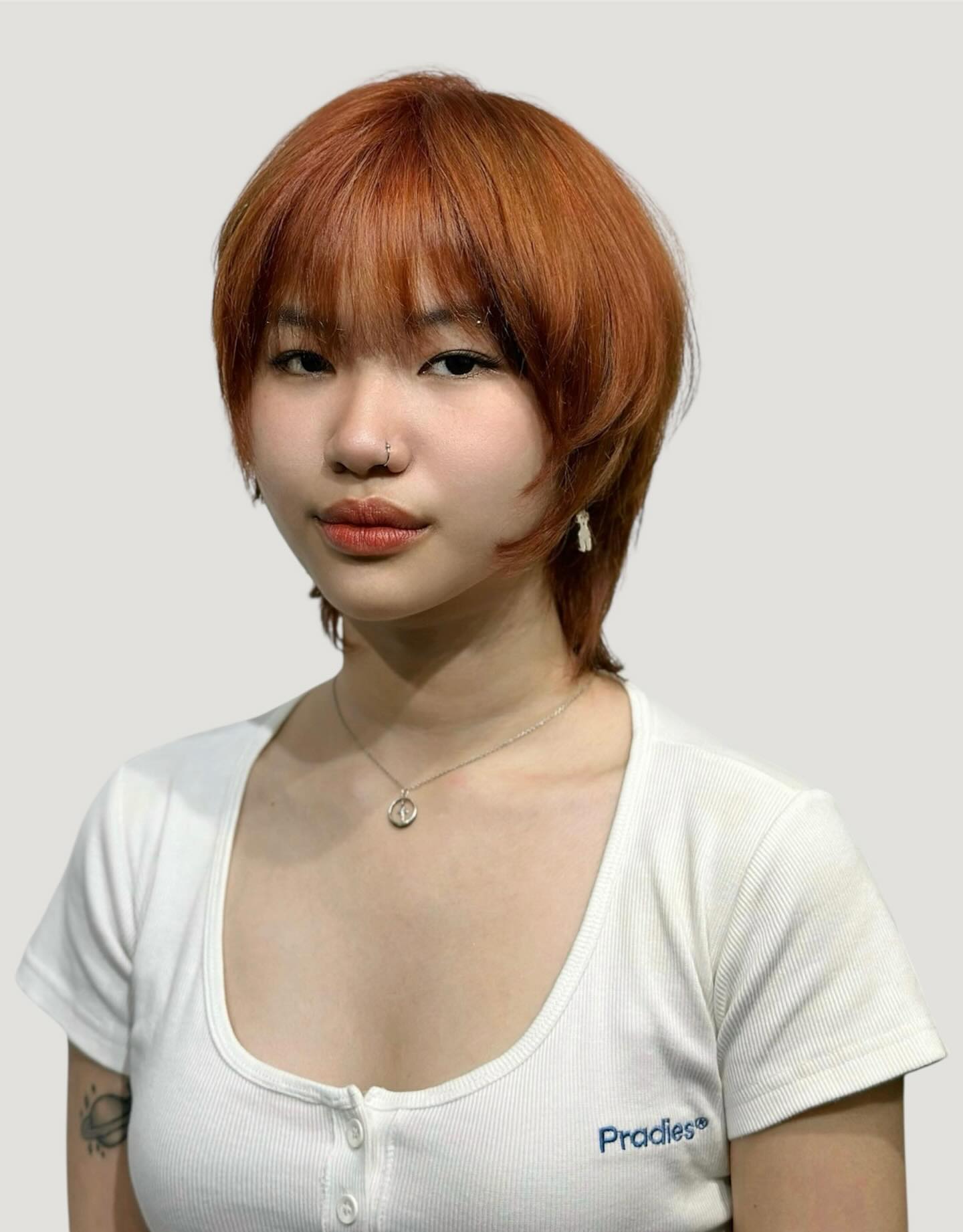 Copper shaggy short wolf cut with subtle face-framing layers