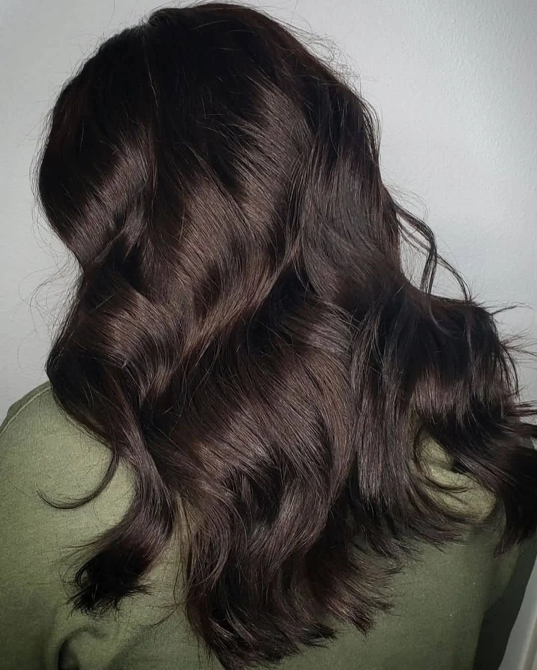 Rich dark brown hair with a polished glow